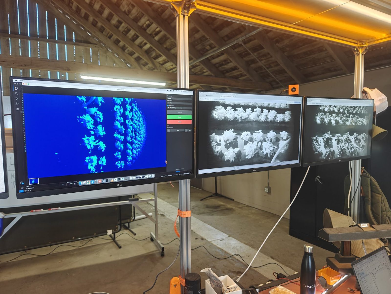 Live crop imaging on the barn screens — NDVI on the left monitor, camera feeds beside it.