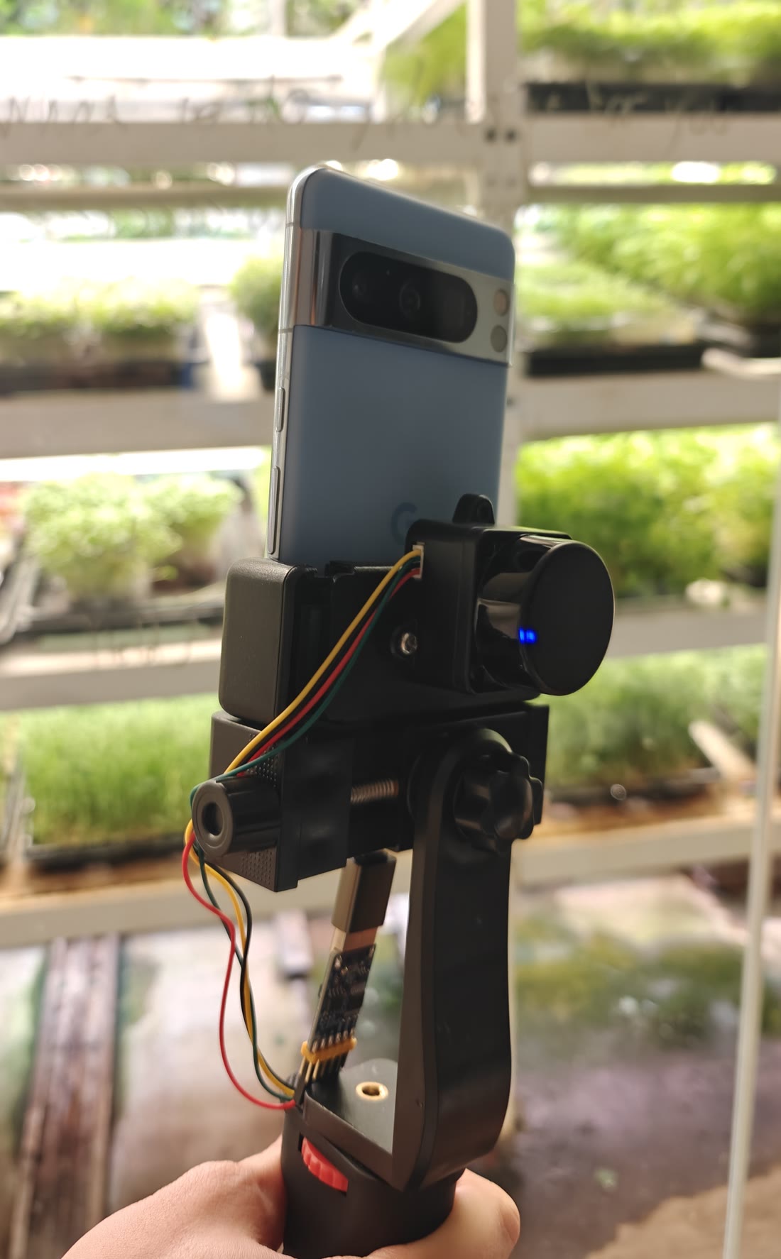 The lidar puck and an Android phone on a printed handheld mount.